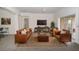Cozy living room featuring brown leather sofas and a large TV at 3526 Valleyview Dr, Kissimmee, FL 34746