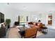 Open living room with brown leather sofas and kitchen view at 3526 Valleyview Dr, Kissimmee, FL 34746