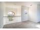 Spacious loft area with an arched window and balcony at 3526 Valleyview Dr, Kissimmee, FL 34746