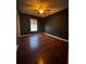 Comfortable bedroom featuring wood floors, a ceiling fan, and natural light from a window at 3710 Black Jack Ct, Lake Wales, FL 33898
