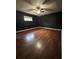Cozy bedroom featuring hardwood floors, a ceiling fan, and a sunlit window at 3710 Black Jack Ct, Lake Wales, FL 33898