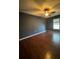 Bedroom with hardwood floors, a ceiling fan, and a large window for natural light at 3710 Black Jack Ct, Lake Wales, FL 33898