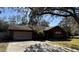 Charming single-story home with a two-car garage, set back from the street with mature trees and landscaping at 3710 Black Jack Ct, Lake Wales, FL 33898