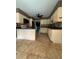 Traditional kitchen featuring tile floors, a breakfast bar, and ample cabinet space at 3710 Black Jack Ct, Lake Wales, FL 33898