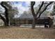 Backyard view of a private screened-in pool, surrounded by trees and landscaping, offering a relaxing outdoor oasis at 3710 Black Jack Ct, Lake Wales, FL 33898