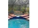 Inviting screened pool and spa with brick and tile accents, perfect for relaxation and entertaining at 3710 Black Jack Ct, Lake Wales, FL 33898