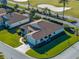 Single-story house with brown roof and landscaped lawn, aerial view at 4195 Muirfield Loop, Lake Wales, FL 33859