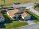 Single-story house with brown roof and landscaped lawn, aerial view at 4195 Muirfield Loop, Lake Wales, FL 33859
