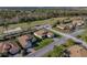 Single-story house with brown roof and landscaped lawn, aerial view at 4195 Muirfield Loop, Lake Wales, FL 33859