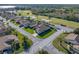 Single-story house with brown roof and landscaped lawn, aerial view at 4195 Muirfield Loop, Lake Wales, FL 33859