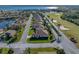 Single-story house with brown roof and landscaped lawn, aerial view at 4195 Muirfield Loop, Lake Wales, FL 33859