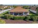 Single-story house with brown roof and screened patio, aerial view at 4195 Muirfield Loop, Lake Wales, FL 33859