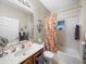 Clean bathroom with tub shower combo, updated vanity and floral shower curtain at 4195 Muirfield Loop, Lake Wales, FL 33859