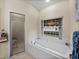 Clean bathroom with a shower and tub at 4195 Muirfield Loop, Lake Wales, FL 33859