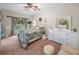 Spacious bedroom with a floral comforter, large dresser, and private access to patio at 4195 Muirfield Loop, Lake Wales, FL 33859