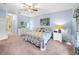 Bright bedroom with light blue walls, and comfortable bedding at 4195 Muirfield Loop, Lake Wales, FL 33859