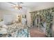 Peaceful bedroom with floral bedding, and sliding glass doors leading to the patio at 4195 Muirfield Loop, Lake Wales, FL 33859