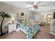 Serene bedroom with floral bedding, comfortable seating area, and private access to patio at 4195 Muirfield Loop, Lake Wales, FL 33859