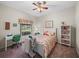 Charming bedroom with floral bedding, desk, and plenty of natural light at 4195 Muirfield Loop, Lake Wales, FL 33859