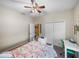 Bright bedroom with floral bedding, built-in shelving, and ample closet space at 4195 Muirfield Loop, Lake Wales, FL 33859