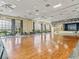 Large community room with hardwood floors and lake views at 4195 Muirfield Loop, Lake Wales, FL 33859