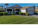 Well-maintained house with a lush lawn, paver driveway, and garage at 4195 Muirfield Loop, Lake Wales, FL 33859