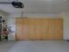 Garage with built-in cabinets and ample storage space at 4195 Muirfield Loop, Lake Wales, FL 33859