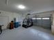 Spacious two-car garage with golf cart and storage at 4195 Muirfield Loop, Lake Wales, FL 33859