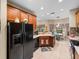 Modern kitchen with stainless steel appliances and wood cabinets at 4195 Muirfield Loop, Lake Wales, FL 33859