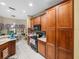 Kitchen with wood cabinets and a black refrigerator at 4195 Muirfield Loop, Lake Wales, FL 33859