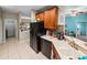 Kitchen with wood cabinets, black appliances, and a corner sink at 4195 Muirfield Loop, Lake Wales, FL 33859