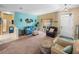 Spacious living room with teal walls, comfortable seating, and ample natural light at 4195 Muirfield Loop, Lake Wales, FL 33859