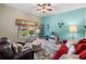 Spacious living room featuring a red couch and a ceiling fan at 4195 Muirfield Loop, Lake Wales, FL 33859