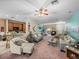 Open concept living room with kitchen views and comfortable seating at 4195 Muirfield Loop, Lake Wales, FL 33859