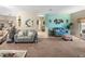 Living room with teal walls, comfortable seating, and open floor plan at 4195 Muirfield Loop, Lake Wales, FL 33859
