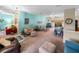 Bright living room featuring a teal accent wall and comfy furniture at 4195 Muirfield Loop, Lake Wales, FL 33859