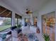 Spacious screened porch with seating and ceiling fan at 4195 Muirfield Loop, Lake Wales, FL 33859