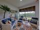 Cozy screened porch with wicker furniture and view at 4195 Muirfield Loop, Lake Wales, FL 33859