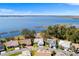 Aerial view of lakeside homes with private docks and large lake, showing surrounding greenery at 462 Sweetwater Way, Haines City, FL 33844