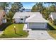 Single-story home with lake view and spacious driveway at 462 Sweetwater Way, Haines City, FL 33844