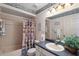 Clean bathroom with shower/tub combo, vanity, and nautical-themed decor at 462 Sweetwater Way, Haines City, FL 33844
