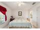 Bedroom with king-size bed and red accents at 462 Sweetwater Way, Haines City, FL 33844