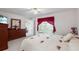 Comfortable bedroom with a queen-size bed and red accents at 462 Sweetwater Way, Haines City, FL 33844