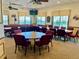 Community room with tables and chairs, perfect for gatherings at 462 Sweetwater Way, Haines City, FL 33844