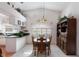 Dining area with a wooden table and chairs, and built-in shelving at 462 Sweetwater Way, Haines City, FL 33844