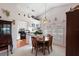 Bright dining area with kitchen views and a charming stained-glass light fixture at 462 Sweetwater Way, Haines City, FL 33844