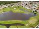 Aerial view of golf course with lake features at 462 Sweetwater Way, Haines City, FL 33844