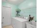 Bright laundry room with washer, dryer, and ample shelving at 462 Sweetwater Way, Haines City, FL 33844