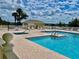 Inviting community pool and spa area with lounge chairs at 462 Sweetwater Way, Haines City, FL 33844