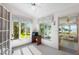 Sunroom with water views and access to a screened porch at 462 Sweetwater Way, Haines City, FL 33844